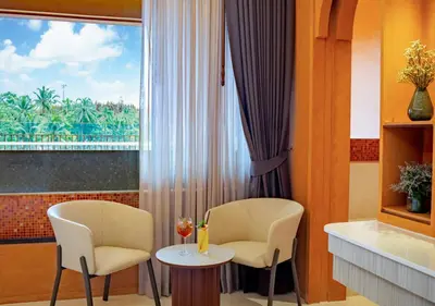 a room with two chairs and a table and a window at Hotel Adam Krabi in Ao Nang Beach
