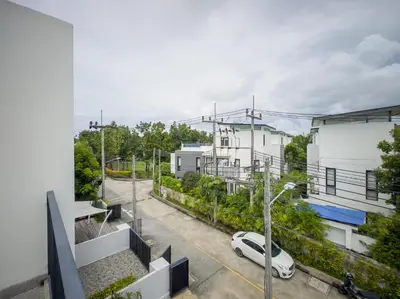 an apartment with a car parked in a parking lot at Townhouse in Laguna Park in Phuket Town