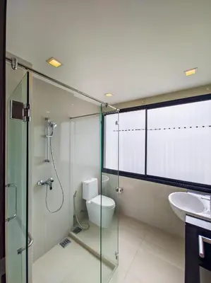 a bathroom with a shower and a toilet and a sink at Townhouse in Laguna Park in Phuket Town