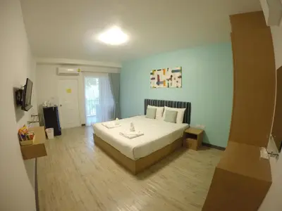 a bedroom with a large bed in a room at Shyne Place in Phuket Town