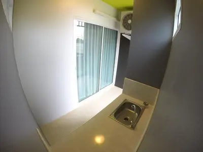 a small bathroom with a sink and a window at Shyne Place in Phuket Town
