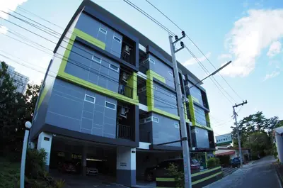 a building with yellow and blue windows on a street at Shyne Place in Phuket Town