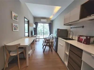 a kitchen and dining room with a table and chairs at The Title Seaview Apartment in Phuket Town