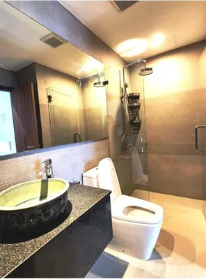 a bathroom with a white toilet and a sink at The Title Seaview Apartment in Phuket Town