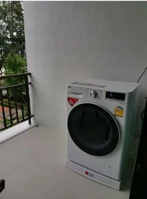a washing machine sitting on top of a balcony at The Title Seaview Apartment in Phuket Town