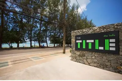 a sign for the hill at the beach at The Title Seaview Apartment in Phuket Town