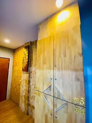 a metal wall with numbers on it in a room at Frutta Hostel in Patong Beach