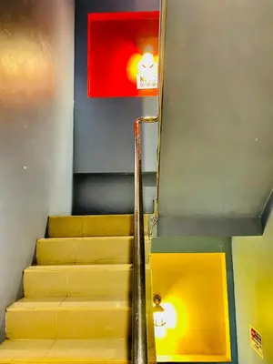 a set of stairs with a red light on the wall at Frutta Hostel in Patong Beach
