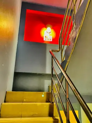 a set of stairs with a sign on the wall at Frutta Hostel in Patong Beach