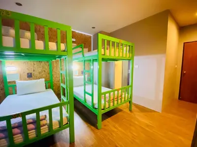 two green bunk beds in a room at Frutta Hostel in Patong Beach