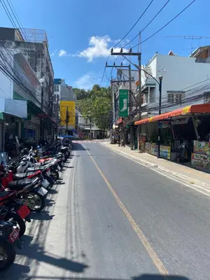 a row of motorcycles parked on the side of a street at Little Mermaid Guesthouse & Restaurant in Kata Beach