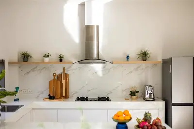 a kitchen with white marble counter tops and a stove at Villa Mimosa 3, Luxury 4Bedroom Private Pool-Rawai in Kata Beach