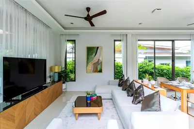 a living room with white furniture and a flat screen tv at Villa Mimosa 3, Luxury 4Bedroom Private Pool-Rawai in Kata Beach