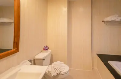 a bathroom with a white toilet and a sink at Best Venue Hotel in Patong Beach