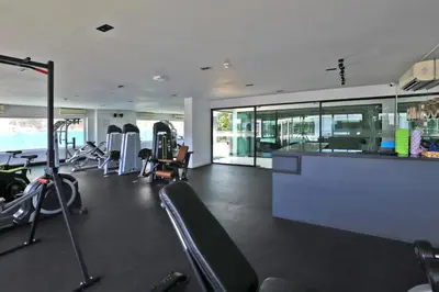 a gym with treadmills and cardio equipment in a building at 1 bdr apartment in Utopia Naiharn by Capital pro in Phuket Town