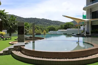 a large swimming pool in front of a building at 1 bdr apartment in Utopia Naiharn by Capital pro in Phuket Town