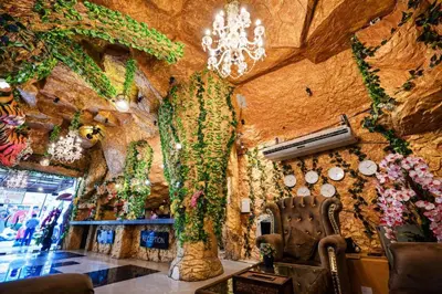 a room with a wall covered in plants at Tiger Complex Hotel in Patong Beach