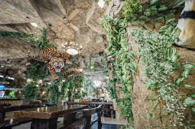 a restaurant with a tiger head on the wall at Tiger Complex Hotel in Patong Beach