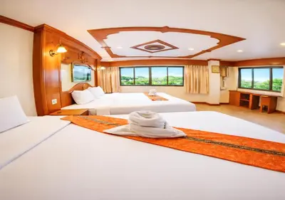 two beds in a large room with two bedsvisor at Tiger Complex Hotel in Patong Beach