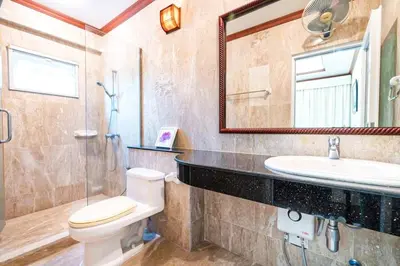 a bathroom with a toilet and a sink and a mirror at Poolvillapanwa in Panwa Beach