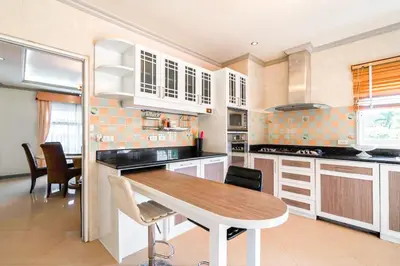 a kitchen with a table and chairs in a room at Poolvillapanwa in Panwa Beach