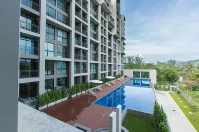 an exterior view of a building with a swimming pool at Sugar Palm Residence in Phuket Town