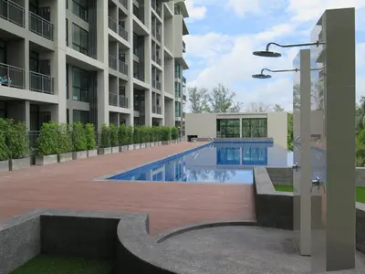 a swimming pool in the middle of a building at Sugar Palm Residence in Phuket Town