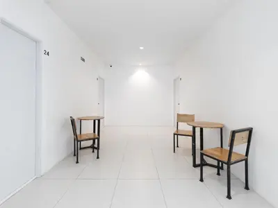 four chairs and tables in an empty room at MoonE in Karon Beach
