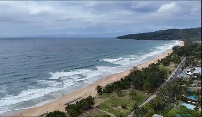 an aerial view of a beach with the ocean at MoonE in Karon Beach