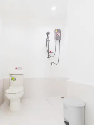 a bathroom with a toilet and a camera on the wall at MoonE in Karon Beach