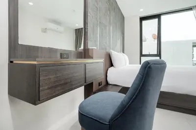 a room with a chair and a desk and a mirror at Scenic Seaview 270 Panorama, 2BR Penthouse VV Patong C701 in Patong Beach