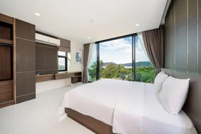 a bedroom with a large bed and a large window at Scenic Seaview 270 Panorama, 2BR Penthouse VV Patong C701 in Patong Beach