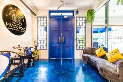 a living room with blue floors and a blue door at Marco Polo Phuket Poshtel & Bistro in Phuket Town