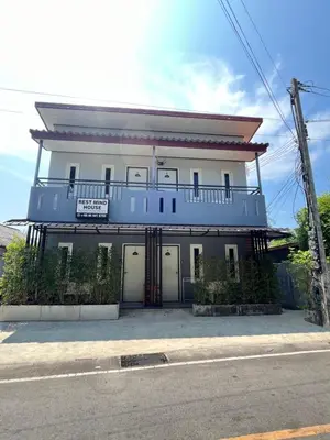 a blue and white building with a balcony at Rest Mind House in Surin Beach