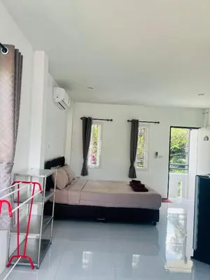 a bedroom with a large bed in a room at Rest Mind House in Surin Beach