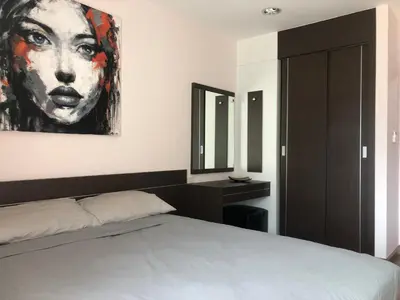 a bedroom with a bed and a painting on the wall at Phuket Villa Patong- Pool View in Patong Beach