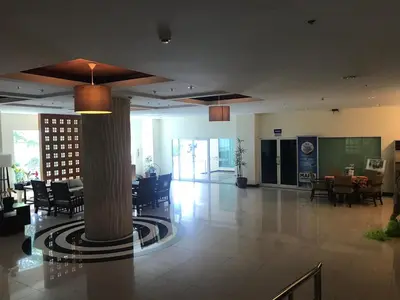 a lobby with a column and tables and chairs at Phuket Villa Patong- Pool View in Patong Beach