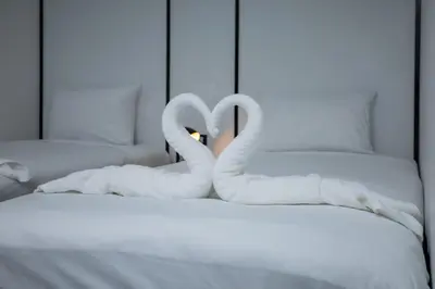 two swans made out of towels on a bed at The Bright House, Koh Phi Phi in Phi Phi Don