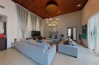a living room with couches and a chandelier at Mandala by Villacarte in Bang Tao Beach
