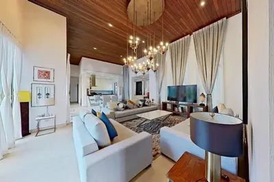 a living room with a couch and a tv at Mandala by Villacarte in Bang Tao Beach