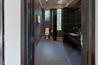 a bathroom with a toilet and a sink at Mandala by Villacarte in Bang Tao Beach