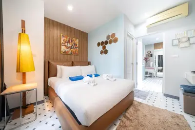 a bedroom with a large white bed in a room at Zcape1 apartment at Boat Avenue by Lofty in Bang Tao Beach