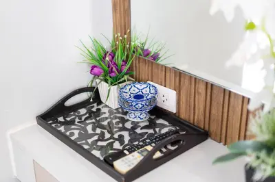 a tray with a vase and remote controls on a shelf at Zcape1 apartment at Boat Avenue by Lofty in Bang Tao Beach