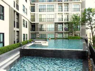 a swimming pool in front of a building at Zcape1 apartment at Boat Avenue by Lofty in Bang Tao Beach