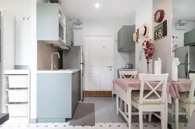 a small kitchen with a table and a refrigerator at Zcape1 apartment at Boat Avenue by Lofty in Bang Tao Beach