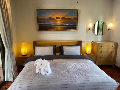 a bedroom with a bed with a towel on it at Luxury Sai Taan Villa in Bang Tao in Bang Tao Beach