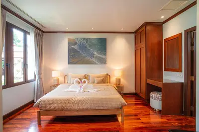 a bedroom with a bed with two swans on it at Luxury Sai Taan Villa in Bang Tao in Bang Tao Beach