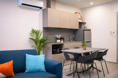 a living room with a blue couch and a table at HOMA Cherngtalay Phuket in Bang Tao Beach