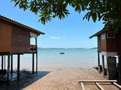 a house on the beach next to the water at Lamsai AC Sea House in Ko Yao Noi