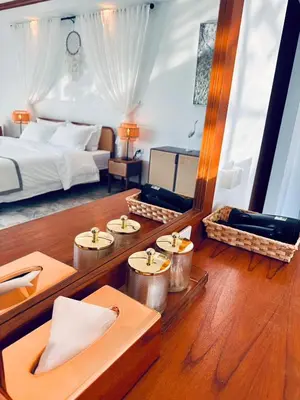 a hotel room with a bed and a table and chairs at Ocean Pie Phuket - Adult Only in Rawai Beach